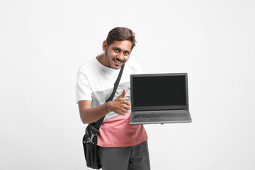 Indian college student showing laptop screen on white background.