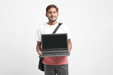 Indian college student showing laptop screen on white background.