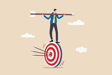 Result oriented business strategy or result driven, professionally set up and achieve business target concept, smart businessman balance and control rotating archery target with arrow hitting bullseye