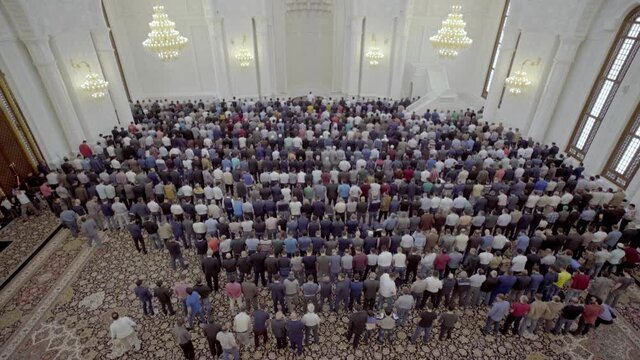 Men attend Friday prayers at a mosque during Ramadan. Muslim pilgrims and worshipers. Muslims pray at the largest mosque in Baku