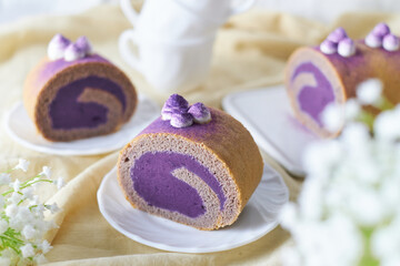 Swiss Roll Cake with sweet purple potato filling set on cafe table.