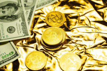 Golden bitcoin coins with a dollars on a golden background. Trading on the cryptocurrency exchange. Cryptocurrency Stock Market Concept. Mining or blockchain technology. Business concept.