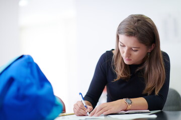 student taking notes for school class