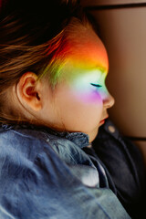Rainbow reflection on the face of a little girl sleeping well