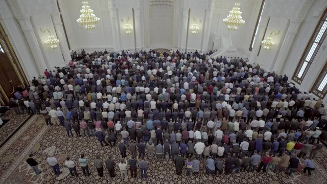 Men attend Friday prayers at a mosque during Ramadan. Muslim pilgrims and worshipers. Muslims pray at the largest mosque in Baku