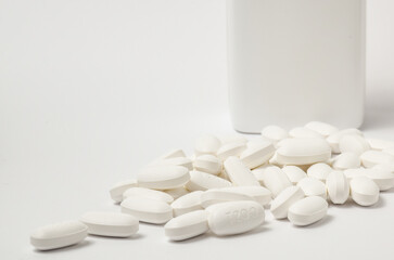 Fototapeta na wymiar white pills on white background