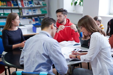 students group working on school project together on tablet computer at modern university