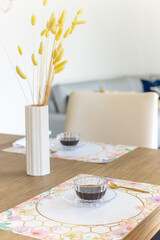 Coffee time. Table decorated with button plant