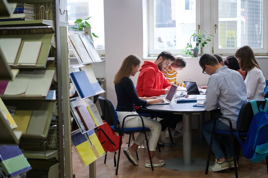 students group working on school project together on tablet computer at modern university