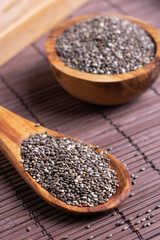 chia seeds on a wooden spoon on the table close-up