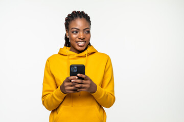 Fototapeta premium Happy african woman texting on her phone isolated over white background
