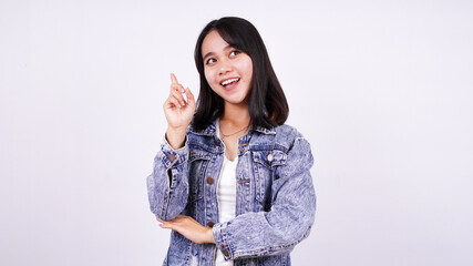 Asian woman smiling wearing jeans jacket and thinking some idea with isolated white background