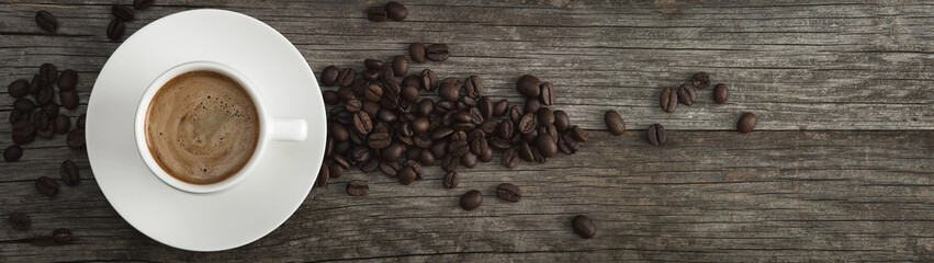 A cup of coffee and coffee beans on the table. .