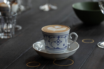 Process of preparing espresso with coffee machine. Cappuccino in  beautiful country style cup.