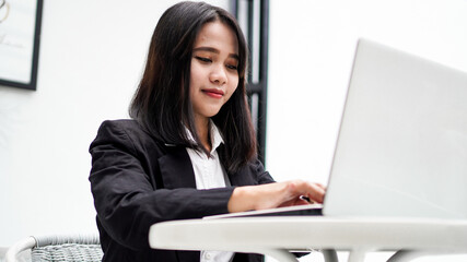 Asian young business woman working on computer in office