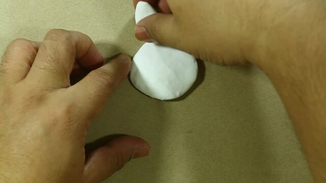 time lapse speed run sculping white plasticine rabbit holding carrot