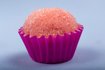 Strawberry brigadeiro covered in sugar, traditional Brazilian sweet.