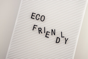 Zero waste concept, pros and cons. Black letters on a peg board with message text Eco friendly on white background. Flat lay.