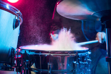 Drummer's rehearsing on drums before rock concert. Man recording music on drumset in studio