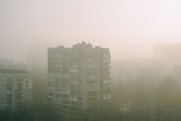 Fototapeta na wymiar Roofs of houses in a residential area of St. Petersburg in heavy fog in the morning