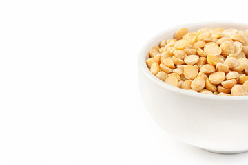 Raw dried uncooked pea beans with ceramic bowl on white background and place for text macro