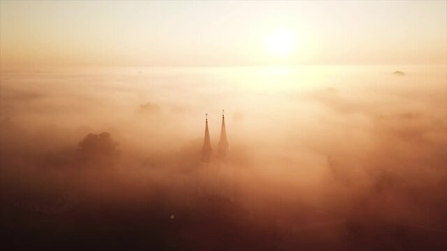 drone footage video of church in the morning fogs sunrise