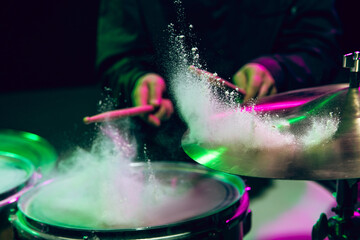 Drummer's rehearsing on drums before rock concert. Man recording music on drumset in studio