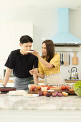 Portrait young couple in love helping to cook In a romantic atmosphere at home with smile face.