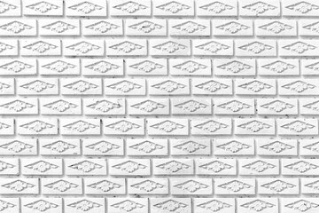 White brick wall with a vintage pattern texture and background seamless