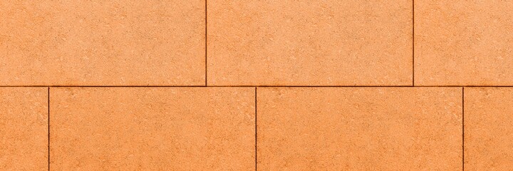 Fototapeta premium Panorama of Building exterior brown granite block wall texture and background seamless