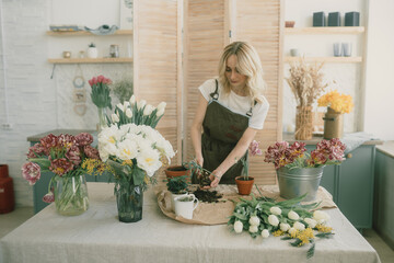 Flower shop. Girl florist makes a beautiful spring bouquet