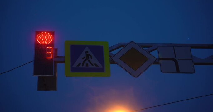 Traffic Signal at Night -- Stop and Go. Red and Green lights on a signal. 4K video. Traffic lights and road signs. Big city