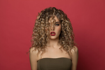 Stylish young woman with curly hair portrait