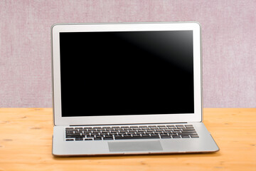 Fototapeta premium Laptop with blank screen for product display in office with modern blurred background