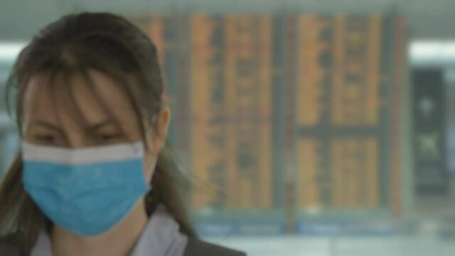 Tourist woman scanning digital health passport on phone in airport, free travel mobility during pandemic