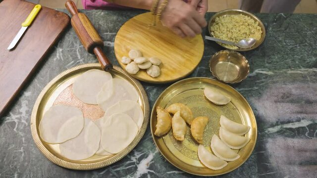 An Indian woman preparing gujia, an Indian popular snack especially made in Holi festival of colors