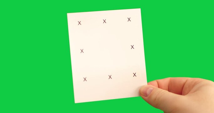 Instant photo with markers in male hand on green background as a template for motion tracking