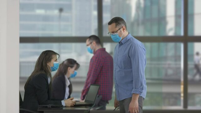 Desk operators scanning digital health certificate passports at the entrance, controlled access during COVID-10 Coronavirus pandemic restrictions