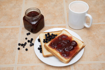 Toast with berries and jam on a stone background