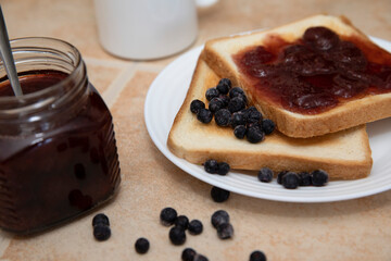 Toast with berries and jam on a stone background