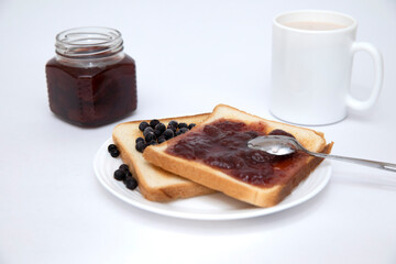 Toast with berries and jam on white background