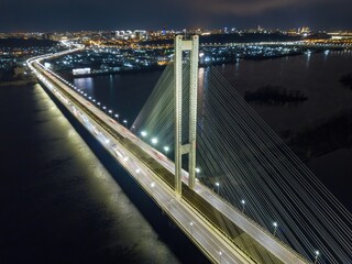 Fototapeta na wymiar South automobile bridge in Kiev. Night illumination of the bridge. Aerial drone view.