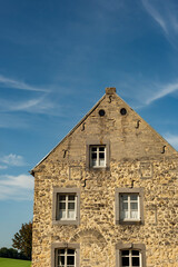 Fototapeta na wymiar Historic house in countryside under a blue sky.