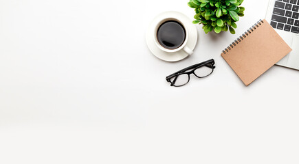 Flat lay, top view office table desk. Workspace with blank, office supplies, pencil, green leaf, and coffee cup on white background.