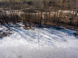 Frozen river in early spring. Aerial drone view.