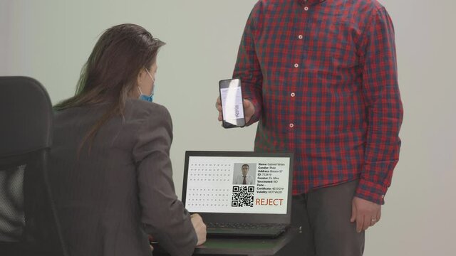 Man being rejected from access after scanning invalid digital health vaccination passport certificate, controlled pass during COVID-10 Coronavirus pandemic restrictions