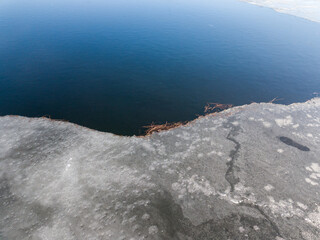 Melting ice edge on the river. Aerial drone view.