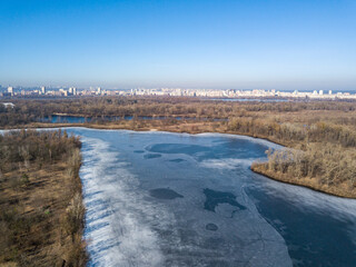 Frozen river in early spring. Aerial drone view.