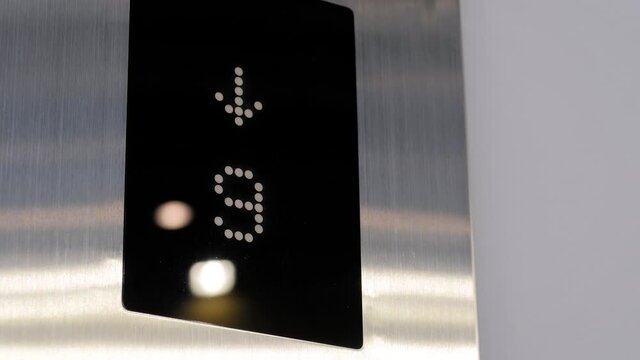 Digital elevator display showing floor number - lift going down and up at mall, hotel or business center - close up view. Technology and transportation concept