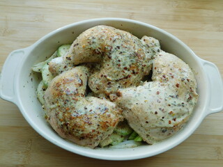 Chicken Legs with Vegetables on wooden table.